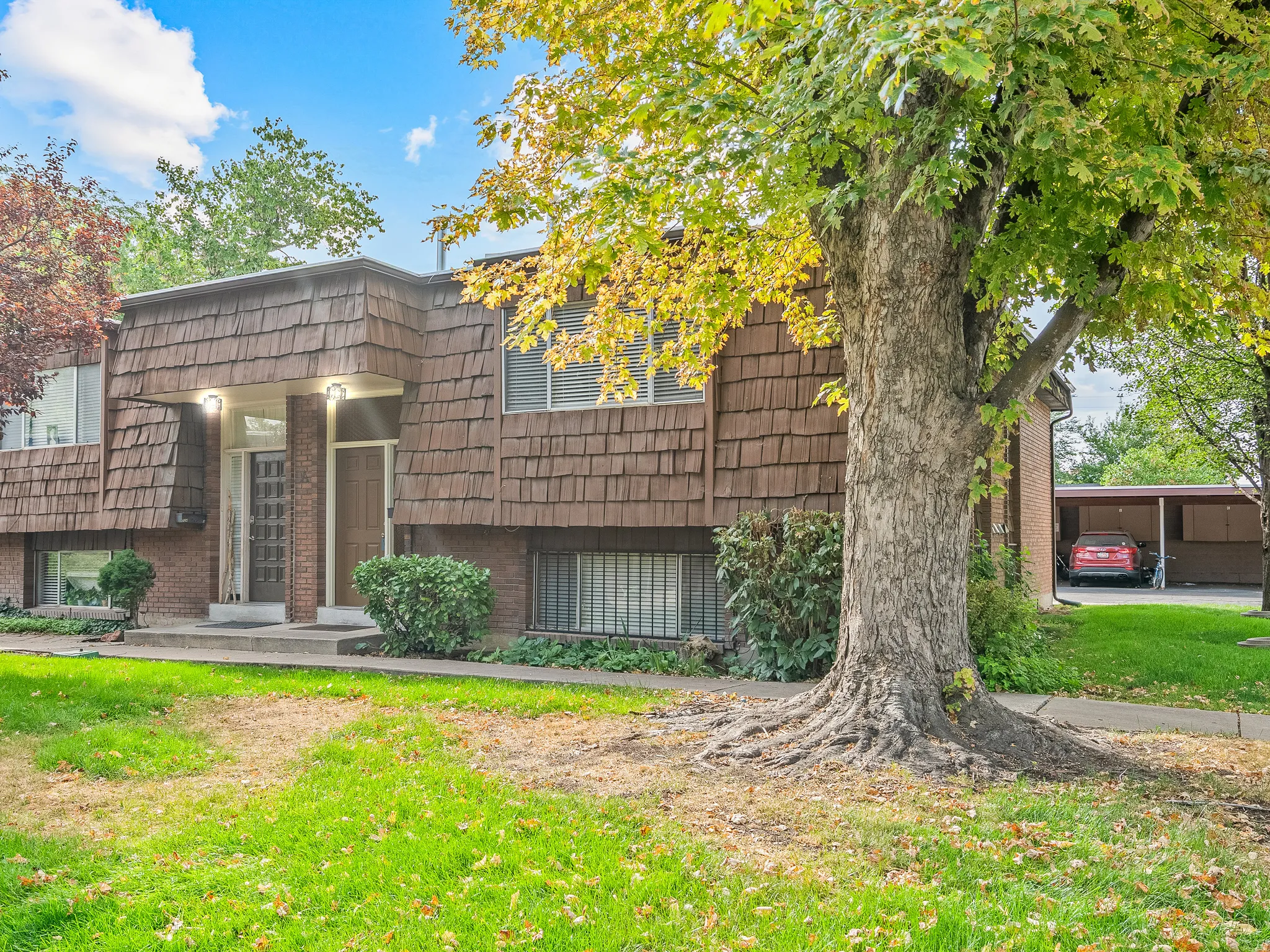 Two-story exterior with shingle siding and brick accents