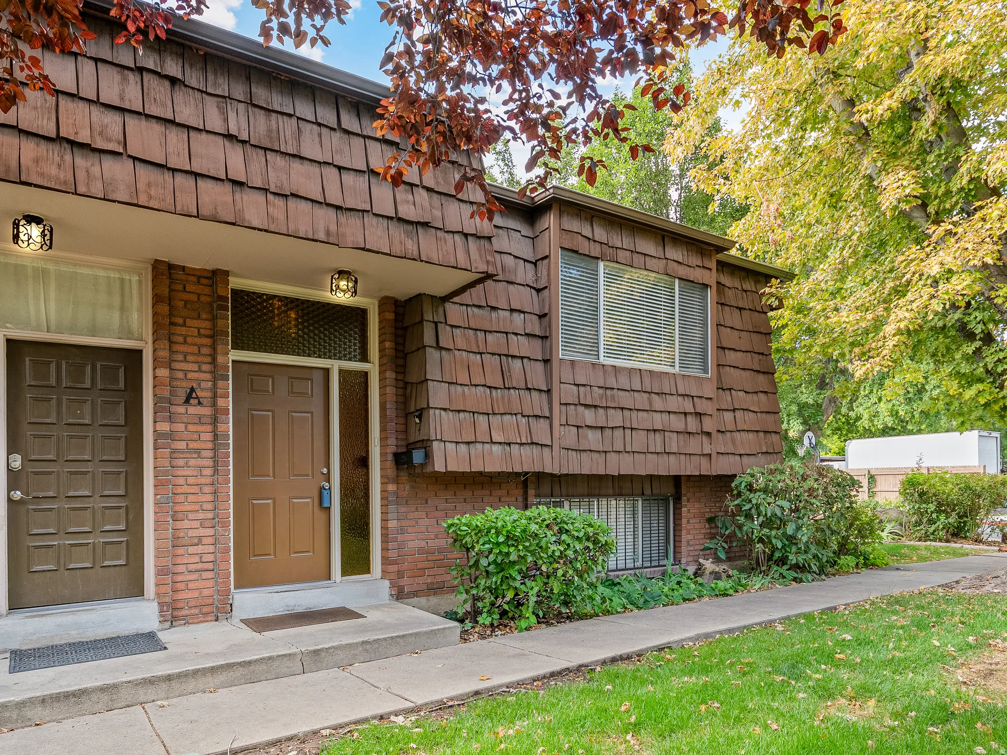 Brick facade with wood-shingle siding