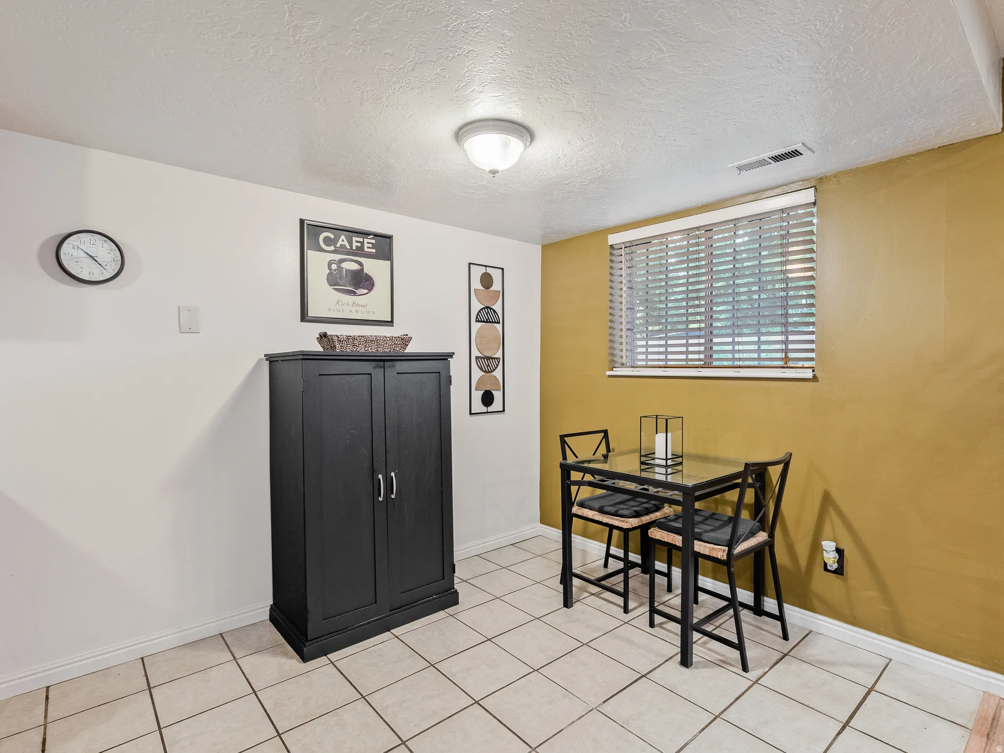 Tile flooring, recessed lighting, built-in cabinetry, and window with blinds