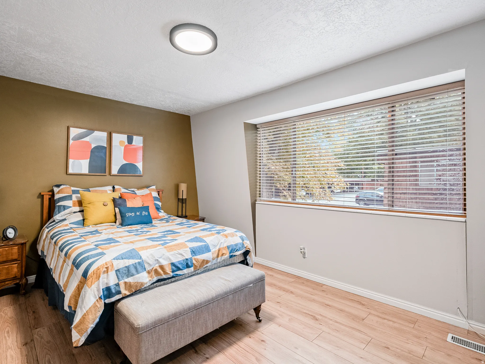 Recessed lighting fixture, wood-finish flooring, full-width window with blinds, two-tone wall paint