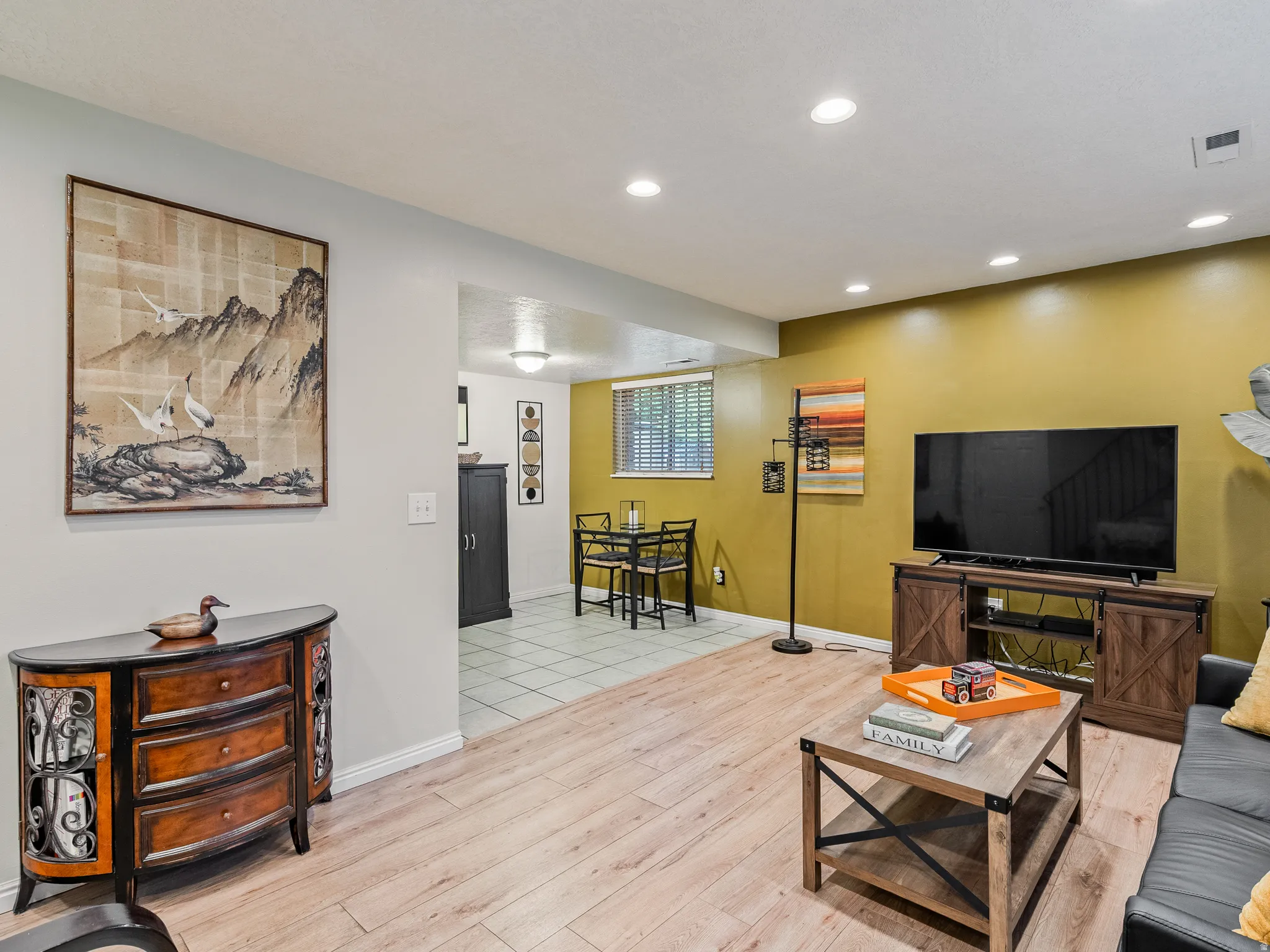 Recessed ceiling lighting, wood-finish flooring, and a separate tiled area