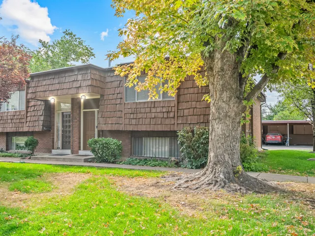 Two-story exterior with shingle siding and brick accents
