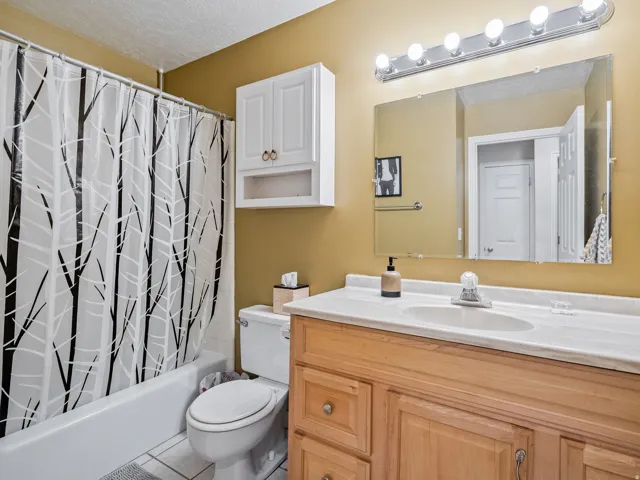 Bathroom featuring a vanity with a light-colored countertop, a built-in sink, and wood-finish cabinetry