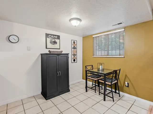 Tile flooring, recessed lighting, built-in cabinetry, and window with blinds