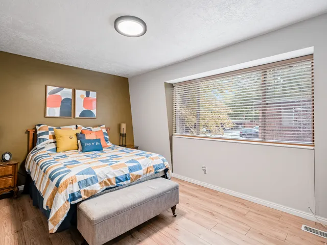 Recessed lighting fixture, wood-finish flooring, full-width window with blinds, two-tone wall paint