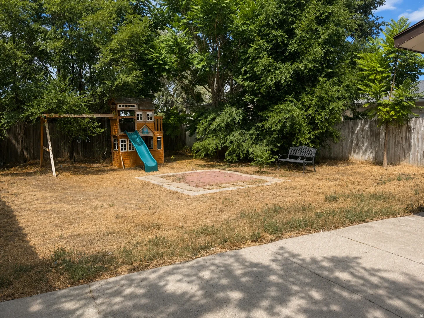 Backyard with play structure, swing set. (Image has been cleaned up using AI)