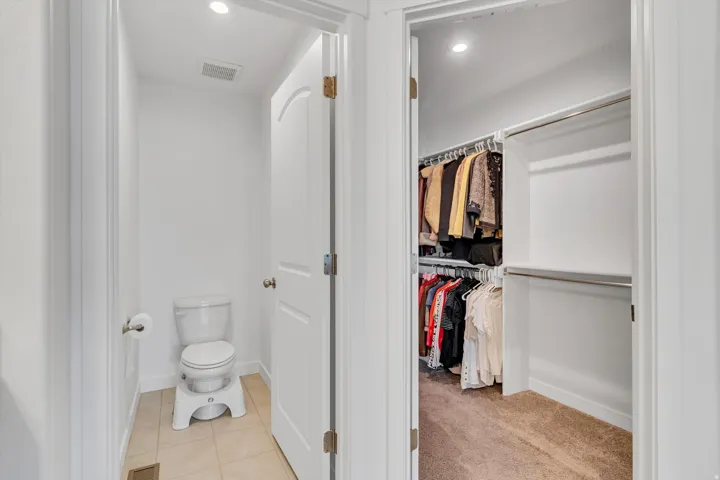 Recessed lighting, tile flooring, and a white toilet