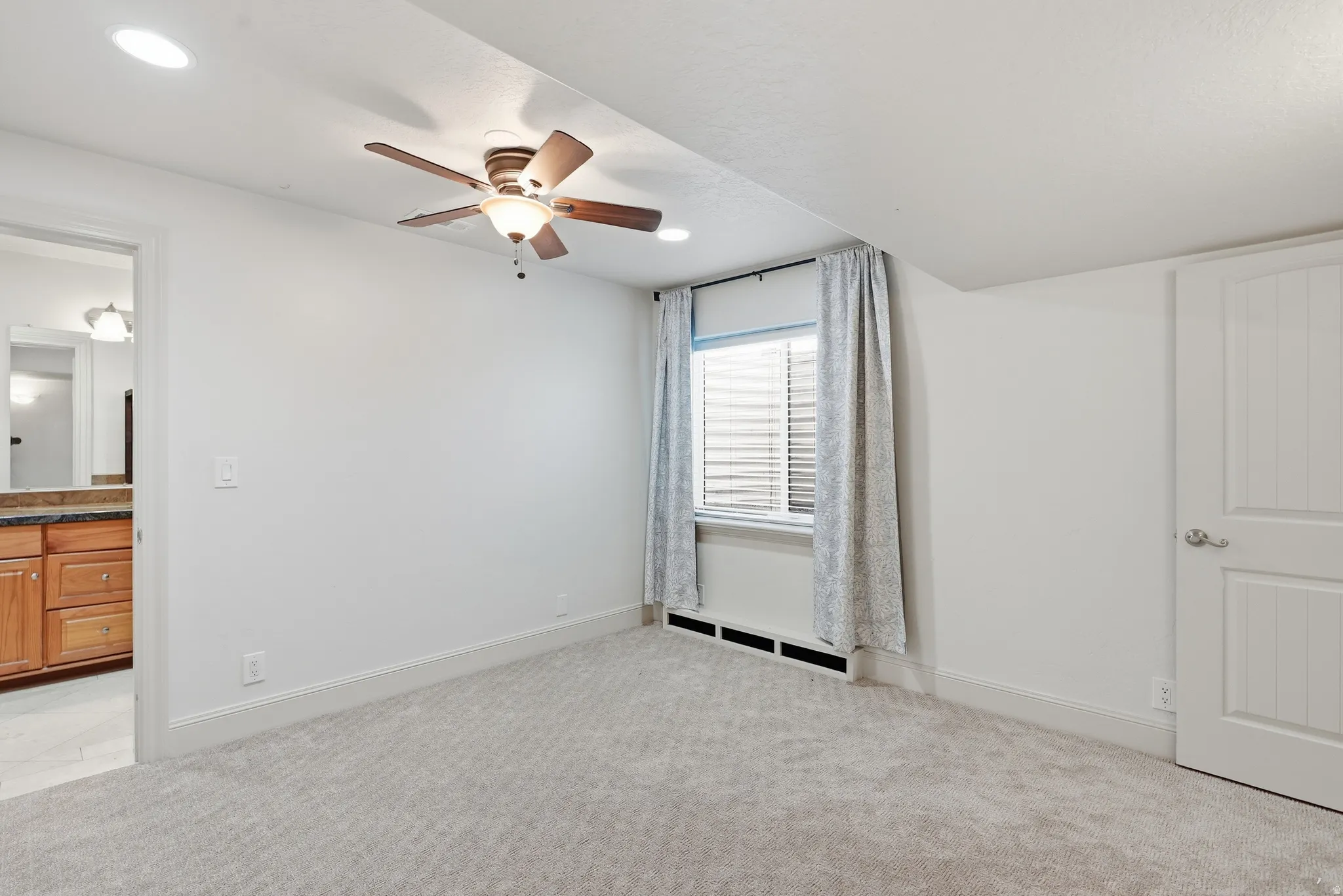 Recessed lighting, ceiling fan, carpeting, and a window with blinds