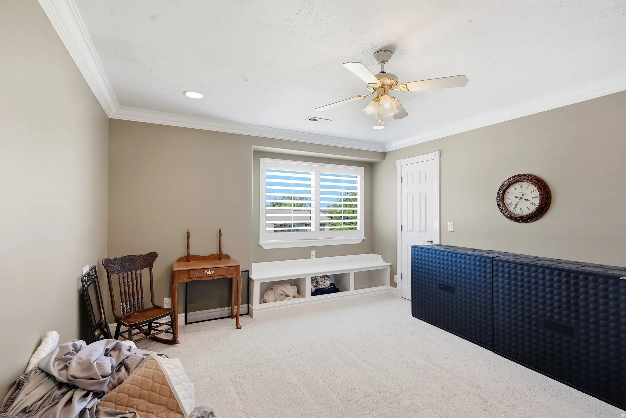 Recessed lighting, crown molding, ceiling fan, window with shutters, built-in window bench