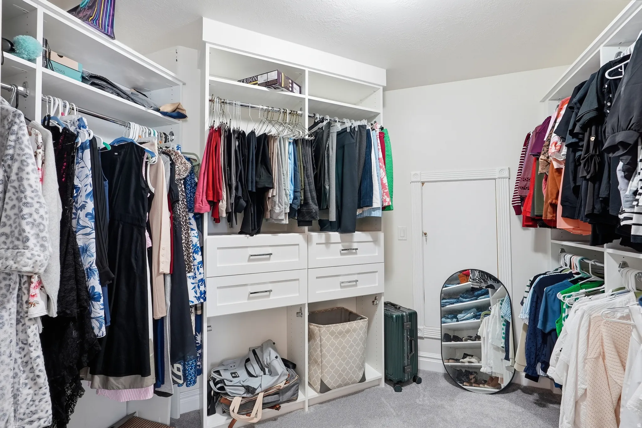 Master Suite: Integrated custom closet system with multiple shelving units, hanging rods, and built-in drawers