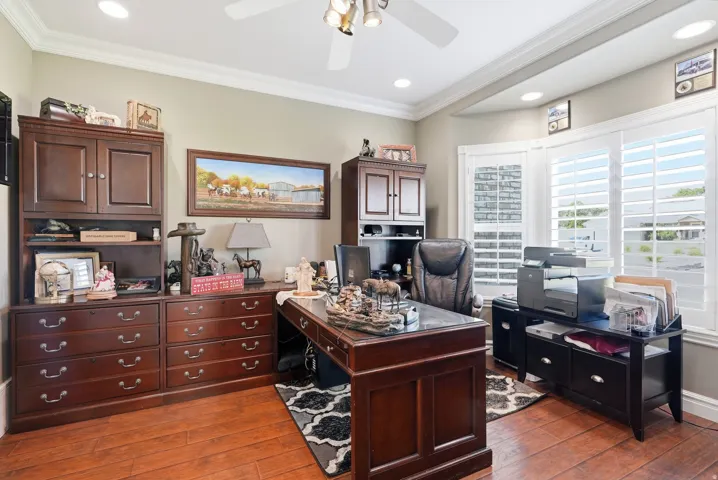 Recessed lighting, wood-finish flooring, crown molding, and plantation shutters