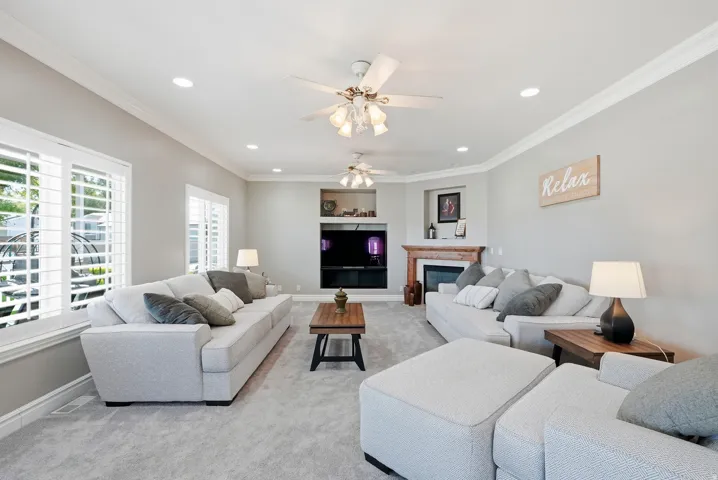 Recessed lighting, crown molding, and two ceiling fans, gas fireplace.