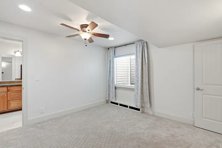 Recessed lighting, ceiling fan, carpeting, and a window with blinds