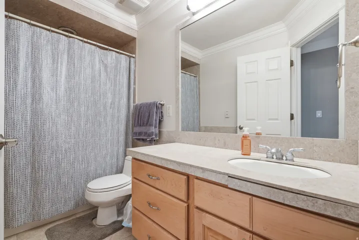 Light wood-finish vanity with a built-in sink and chrome faucet