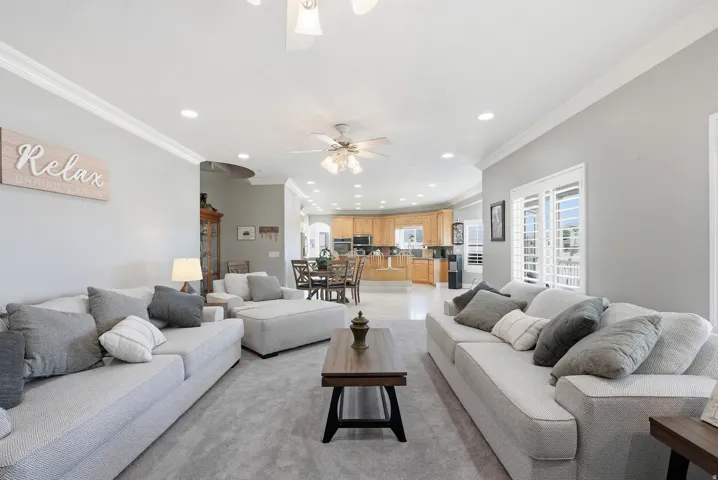 Recessed lighting, crown molding, ceiling fan, carpet flooring, and plantation shutters