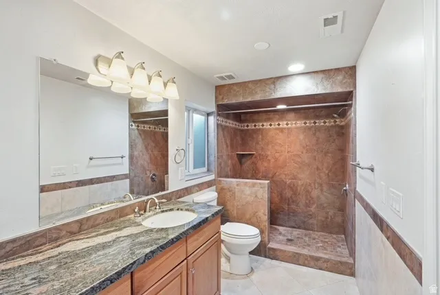 Integrated vanity with a single basin sink, granite countertop, and wood-finish cabinetry