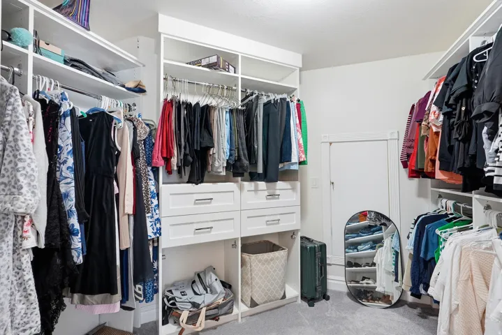 Master Suite: Integrated custom closet system with multiple shelving units, hanging rods, and built-in drawers