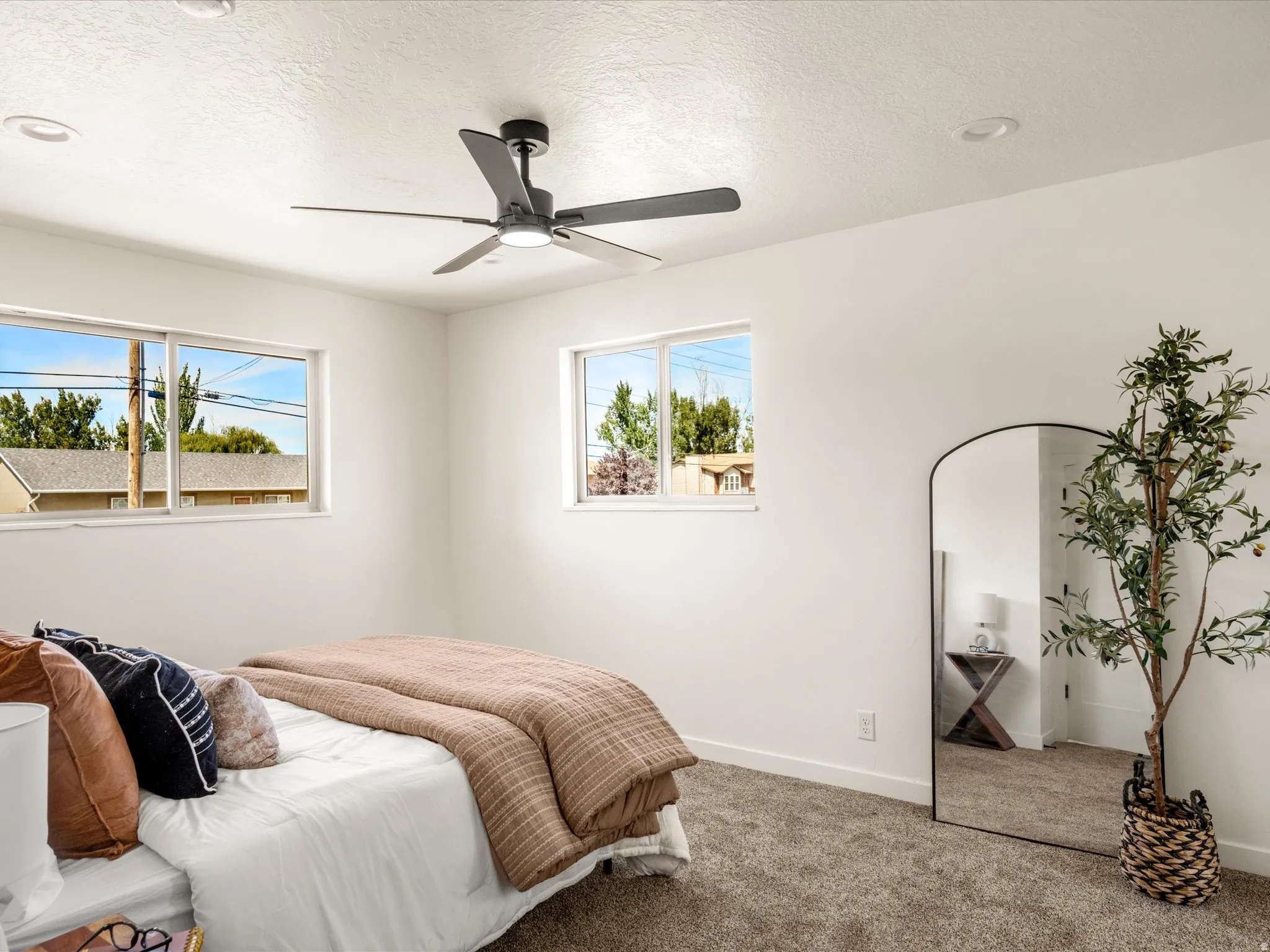 Primary Bedroom Recessed lighting, ceiling fan, two windows, and carpeted flooring