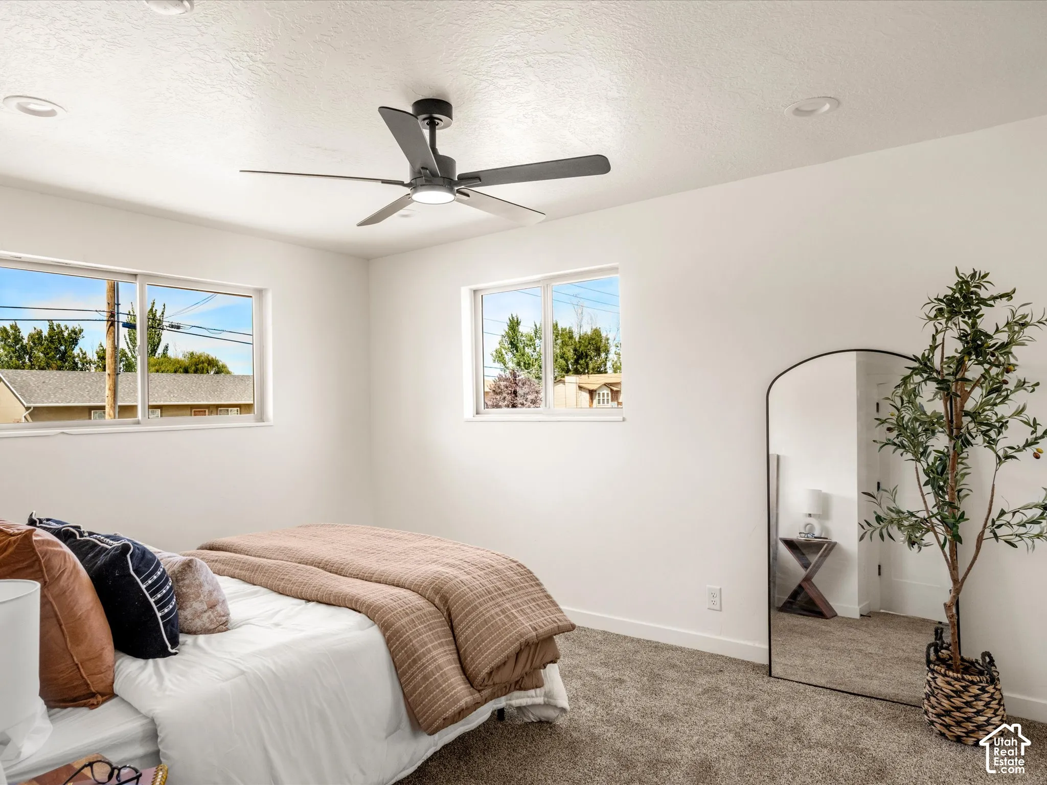 Primary Bedroom Recessed lighting, ceiling fan, two windows, and carpeted flooring