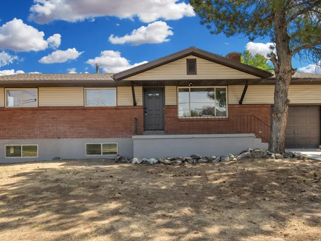 Brick and siding exterior with a multi-pane entry door, front porch, and an attached garage