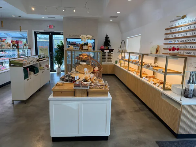 Polished concrete flooring, recessed lighting, and track lighting illuminate the retail space