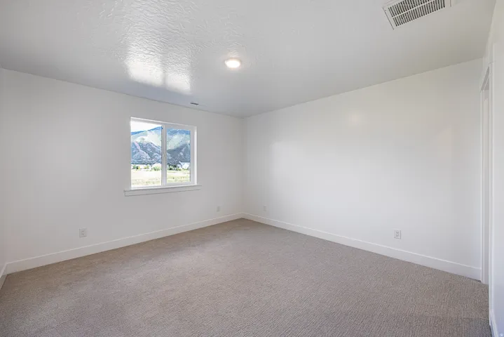 Neutral-toned carpeting complements bright white walls