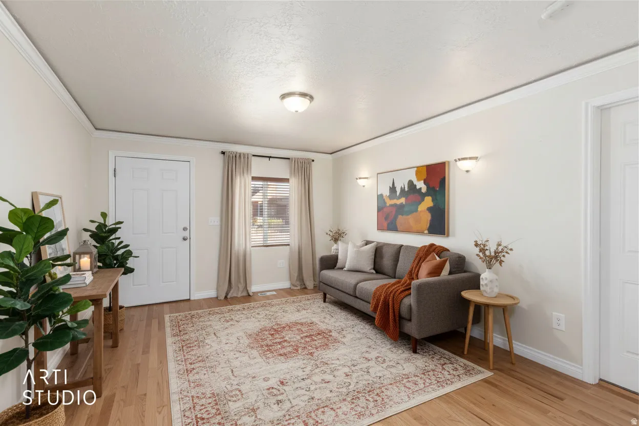 Wood-finish flooring, crown molding, wall-mounted sconces, and a multi-pane window with blinds. (photo is digitally staged with ai)