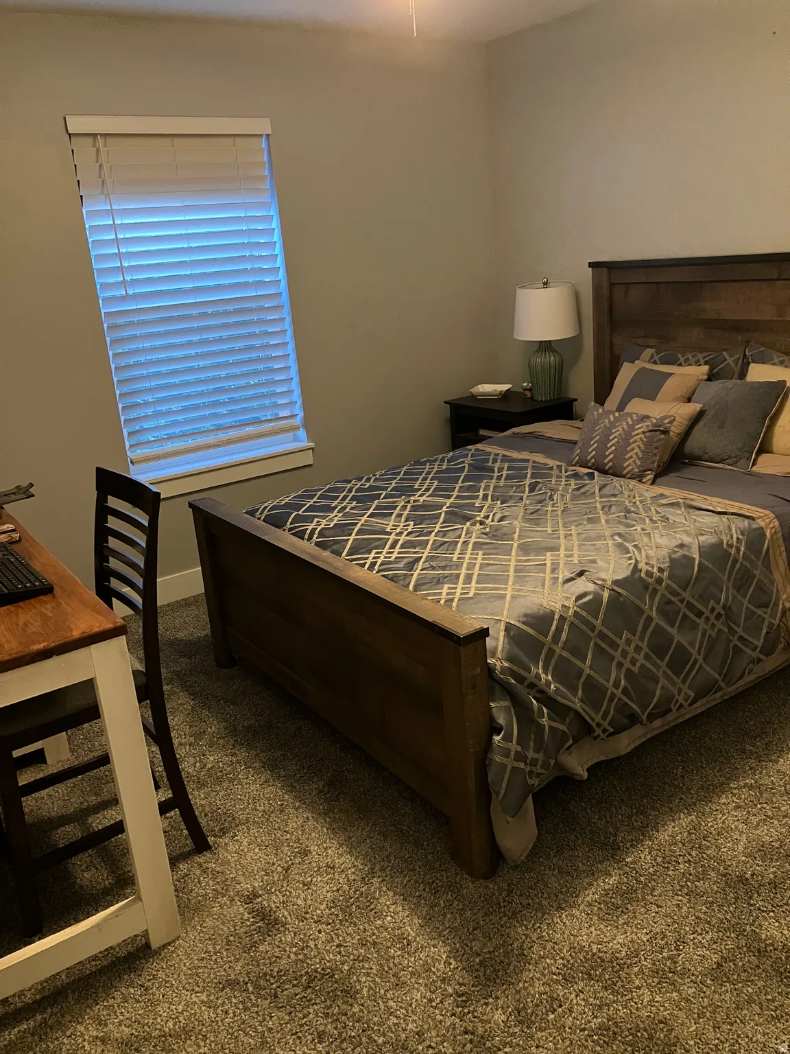 Carpeted flooring, window with blinds, and neutral wall paint