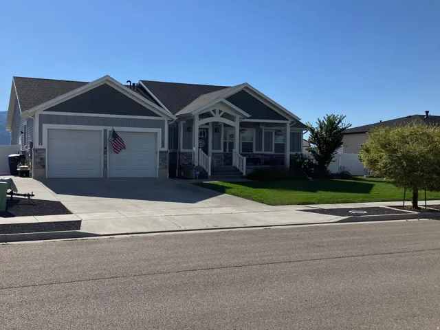 Exterior with light gray siding and stone accents
