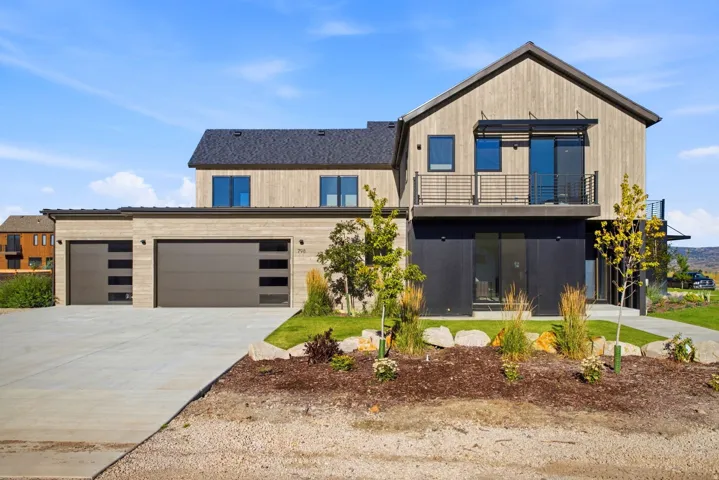 Modern architectural design featuring vertical wood-finish siding and dark accent panels
