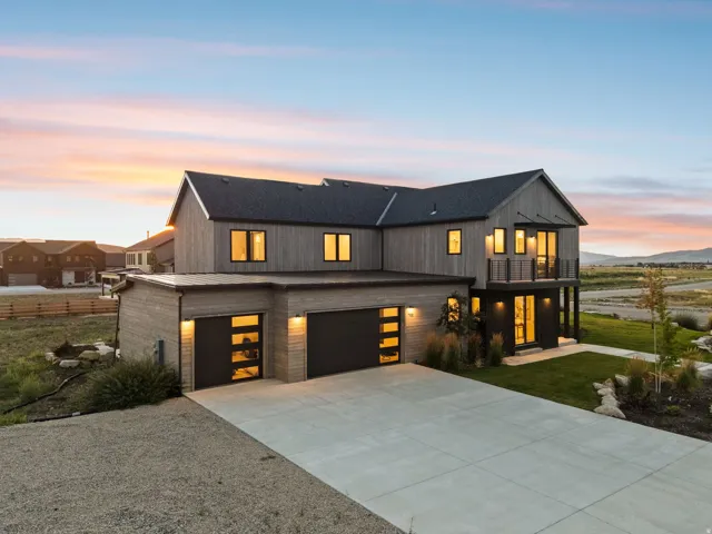 Modern farmhouse architecture featuring horizontal wood siding and a dark roof