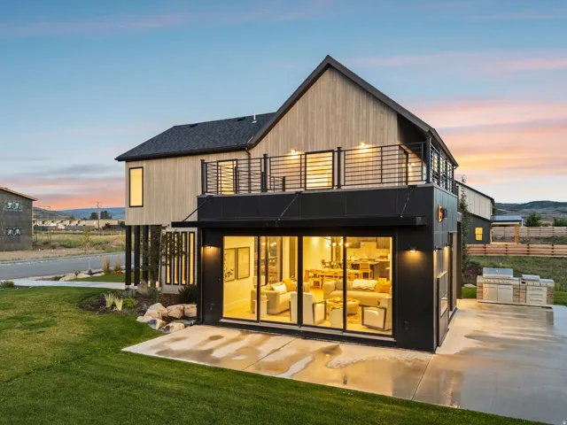 Modern architectural exterior with wood-finish siding and a dark roof