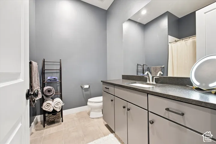 Vanity with integrated sink, dark countertop, and matte silver-finish hardware