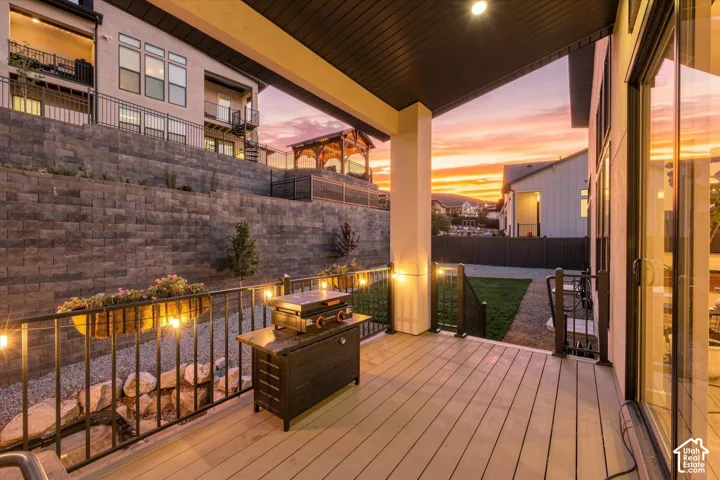 Covered outdoor patio with composite decking, recessed lighting, and sliding glass doors