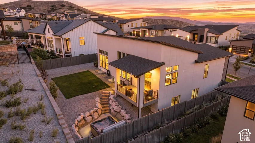 Contemporary two-story exterior with multiple windows, private balcony, and a flat roofline