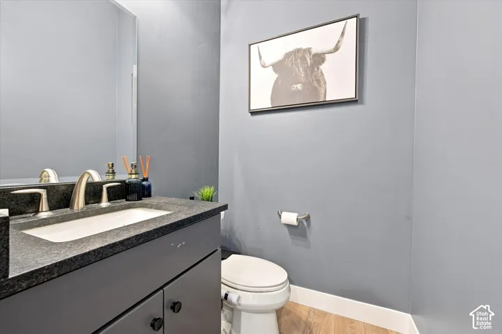 Vanity with dark countertop, undermount sink, and brushed nickel faucet