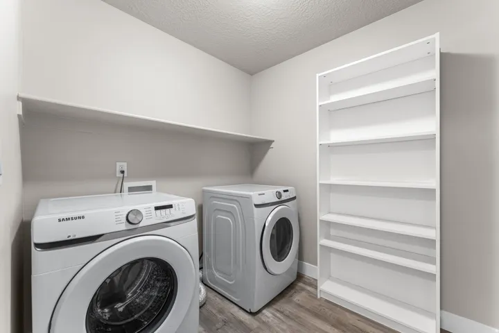 Built-in shelving, a permanent wall shelf, and wood-finish flooring