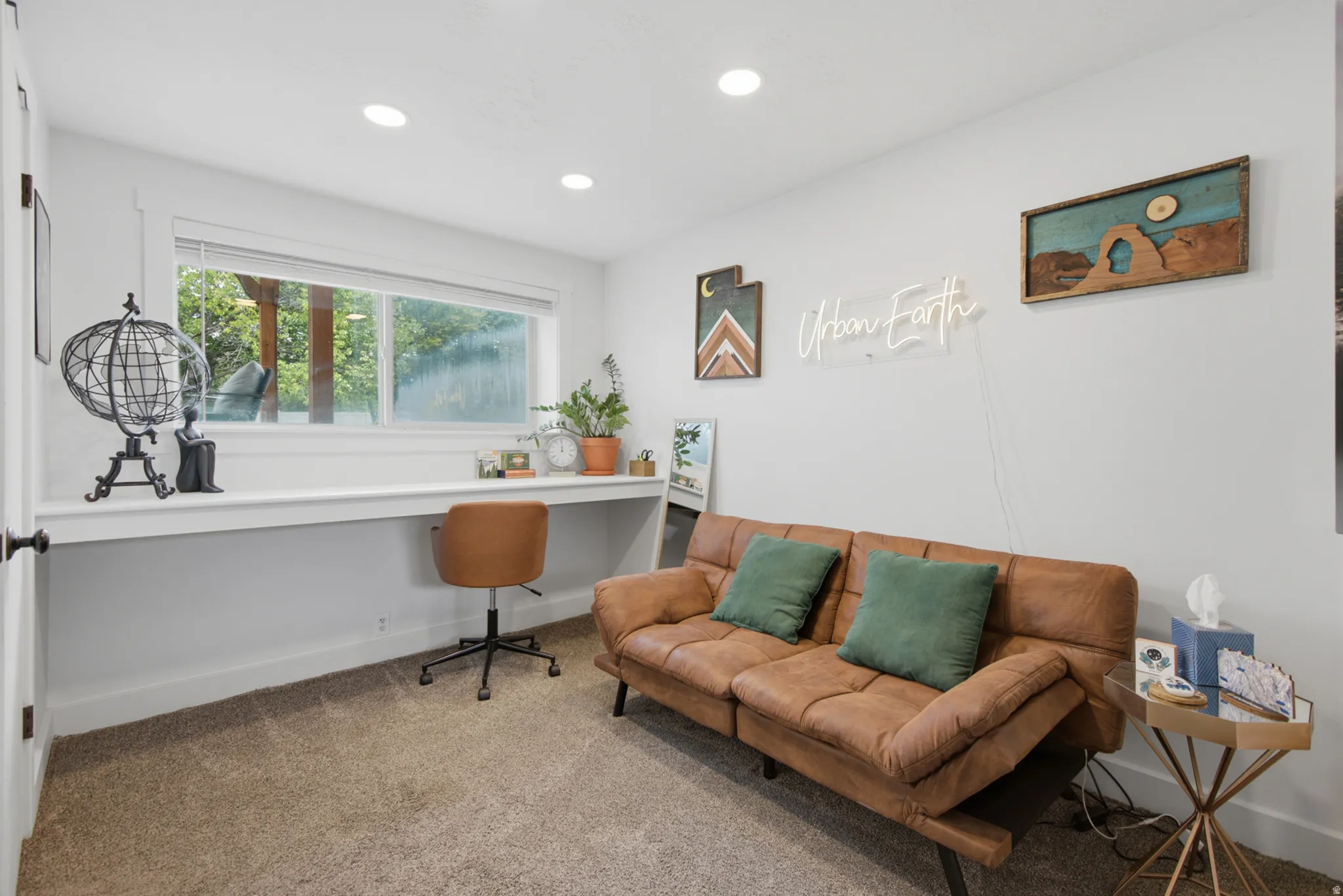 Recessed ceiling lighting, built-in desk, large window, neutral wall paint, and carpeted flooring