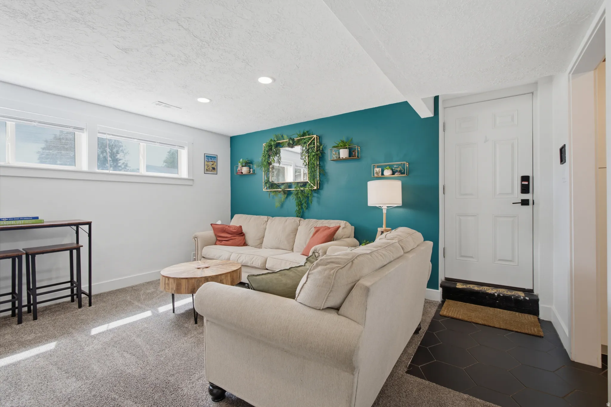 Recessed lighting, wood-finish shelving, and a paneled entry door