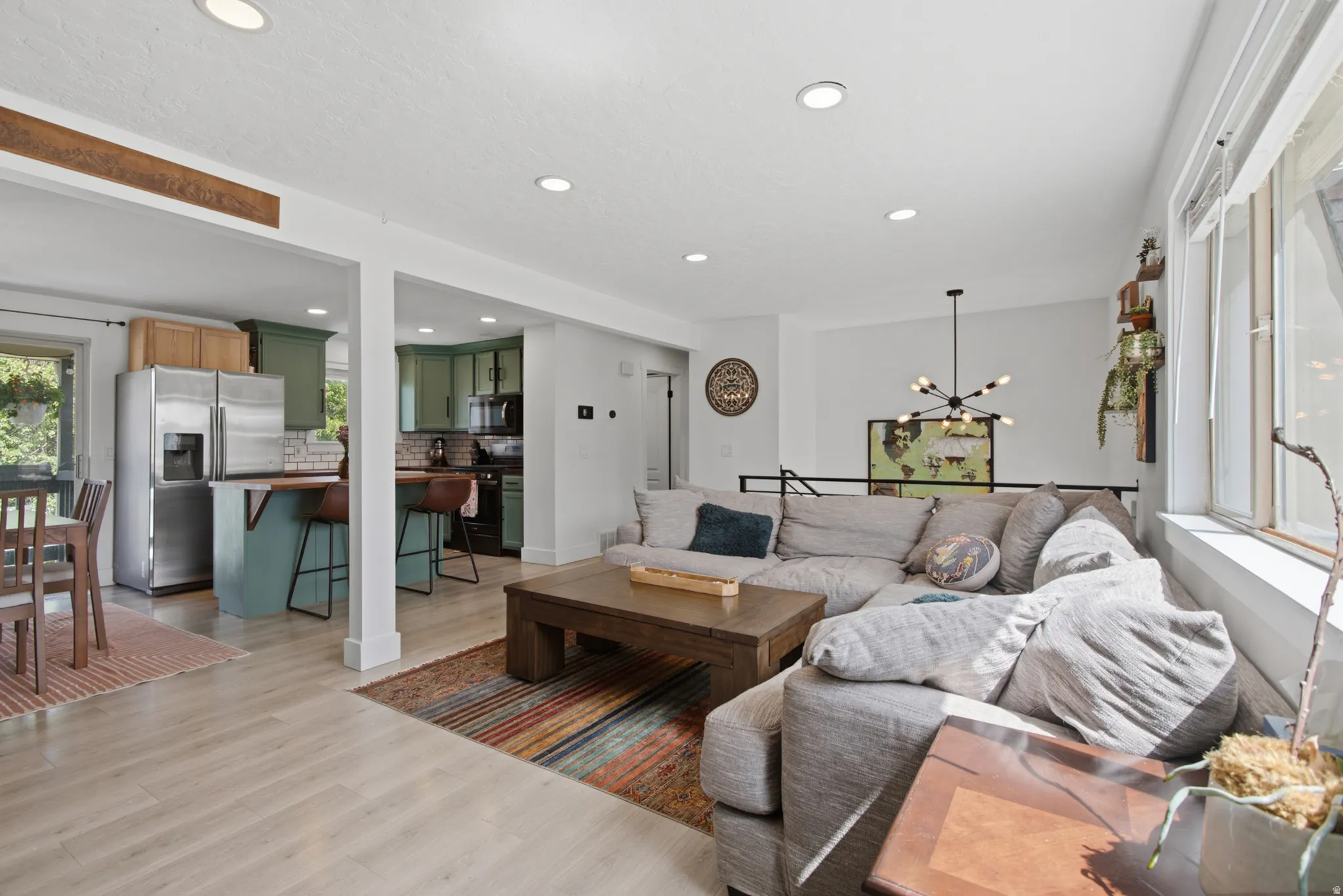 Recessed ceiling lighting, light wood-finish flooring, and white walls