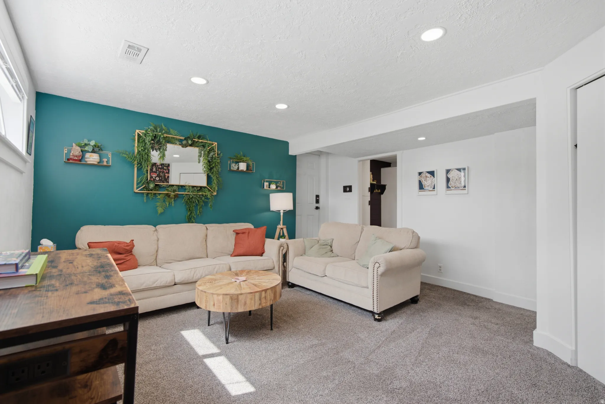 Recessed ceiling lighting, textured carpet flooring, white painted walls, accent wall, and built-in closet