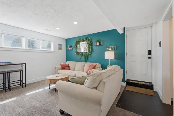 Recessed lighting, wood-finish shelving, and a paneled entry door