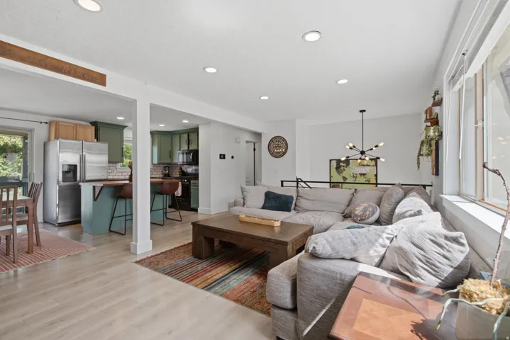 Recessed ceiling lighting, light wood-finish flooring, and white walls