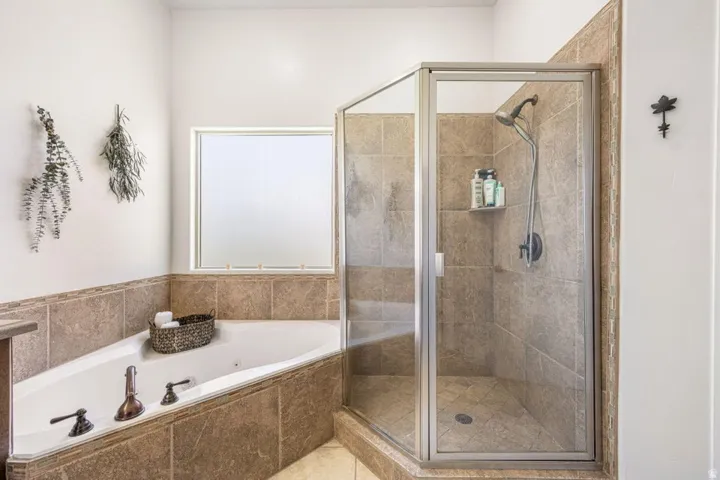 Built-in corner soaking tub with bronze-tone fixtures