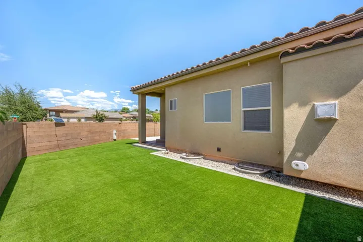 Stucco exterior with a tile roof and covered patio