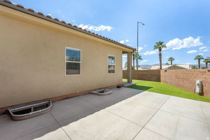 Exterior featuring stucco siding, tile roofing, and a concrete patio
