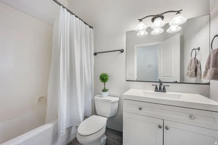 White vanity with integrated sink and matte black faucet