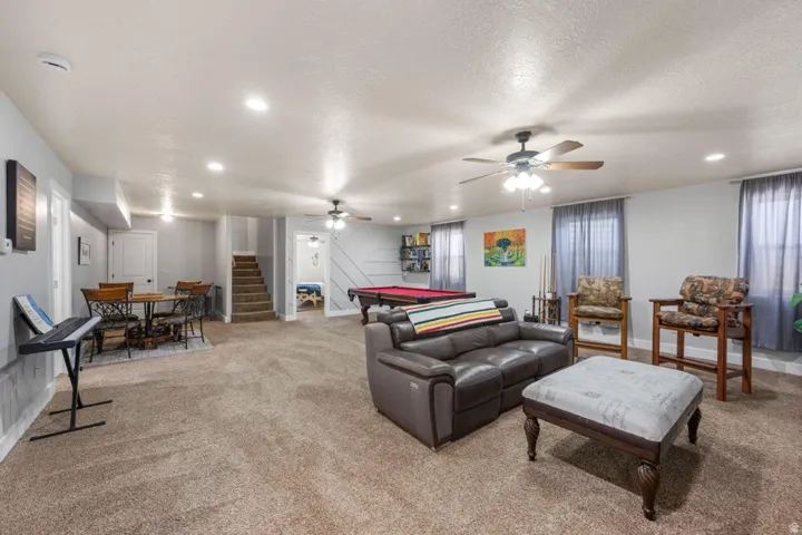Recessed lighting, ceiling fans, light gray walls, white trim, and a billiards table