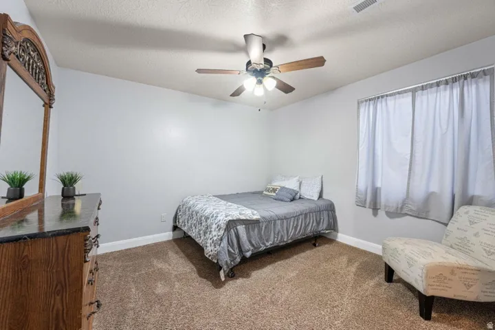 Recessed lighting, wood-finish ceiling fan, and light-toned wall paint