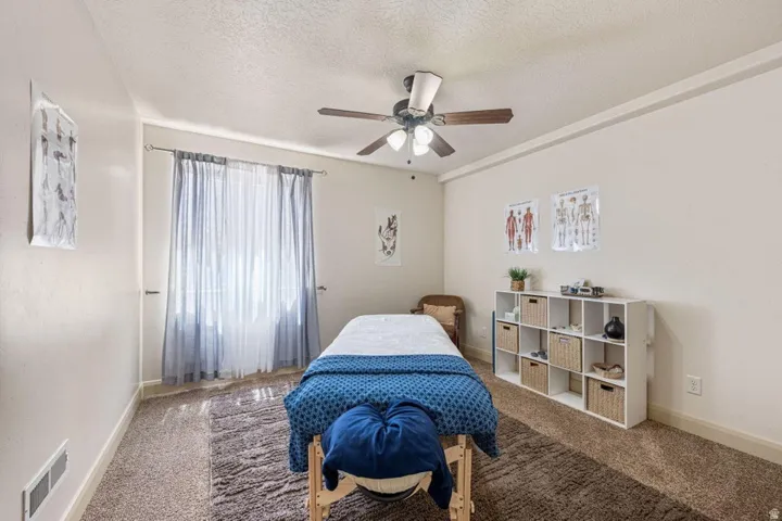 Recessed lighting, wood-finish ceiling fan, crown molding, and light-toned walls